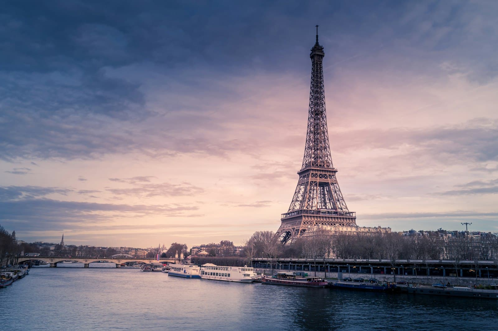 The Eiffel Tower above the Seine at dusk