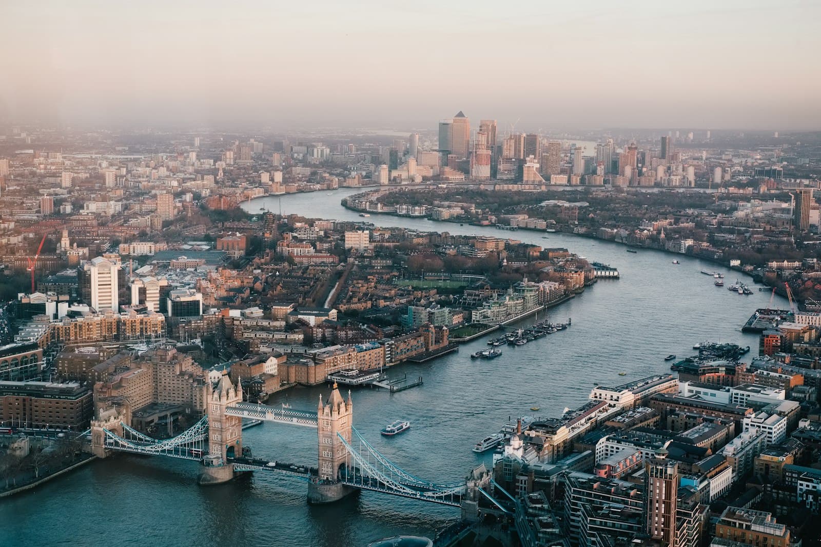 An aerial view of London along the Thames with Tower Bridge